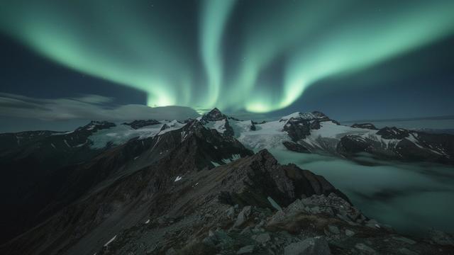 Aurora-themed event banner with mountains and neon lights